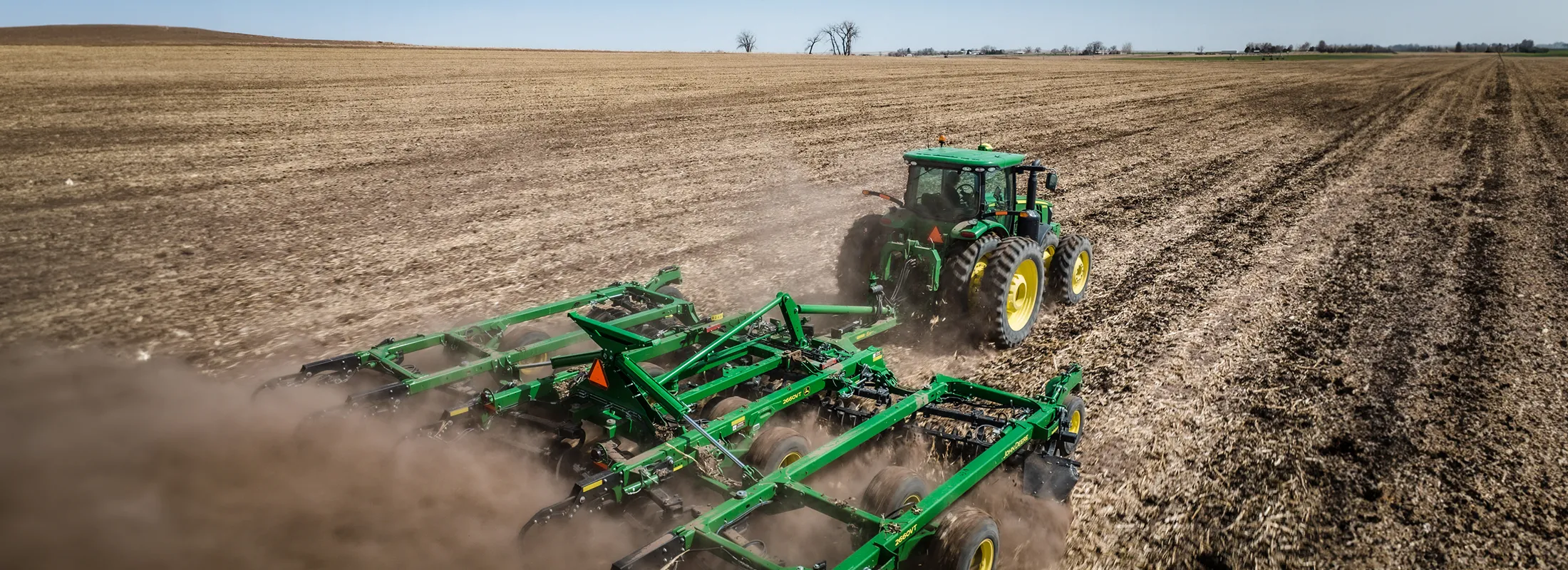 advantages of farm equipment leasing tractor rolling in a field