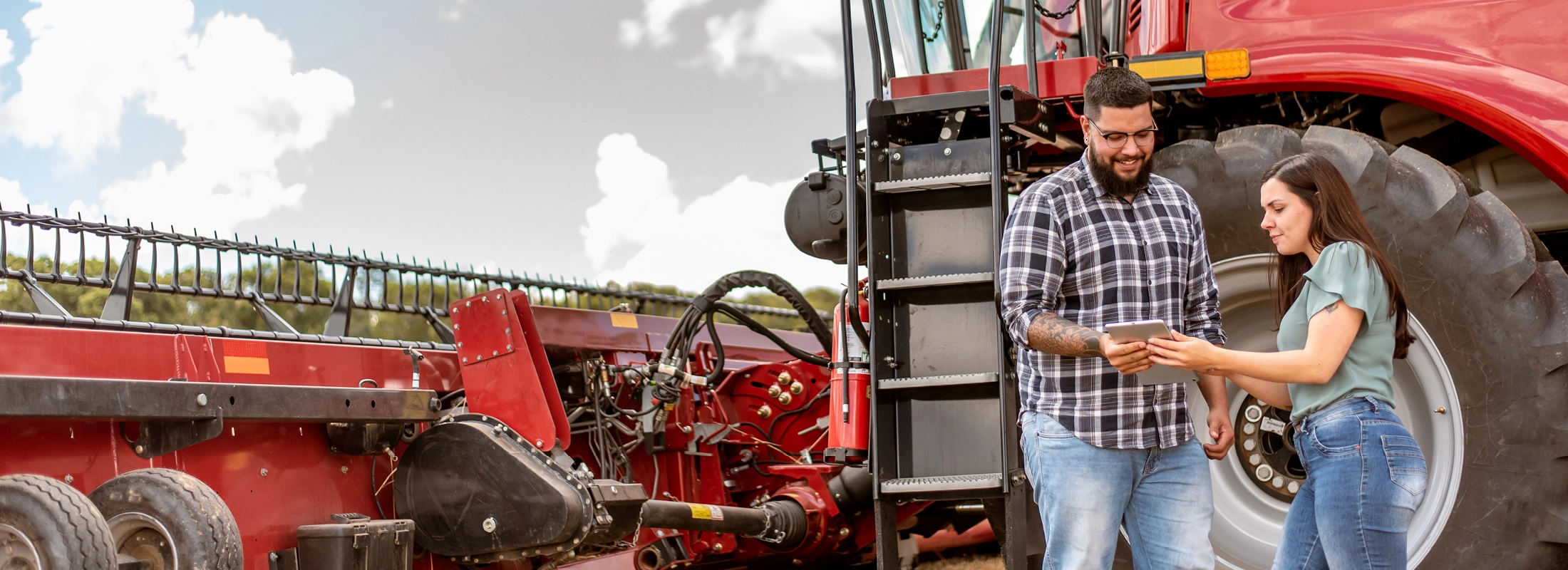 People standing in front of ag equipment People standing in front of ag equipment