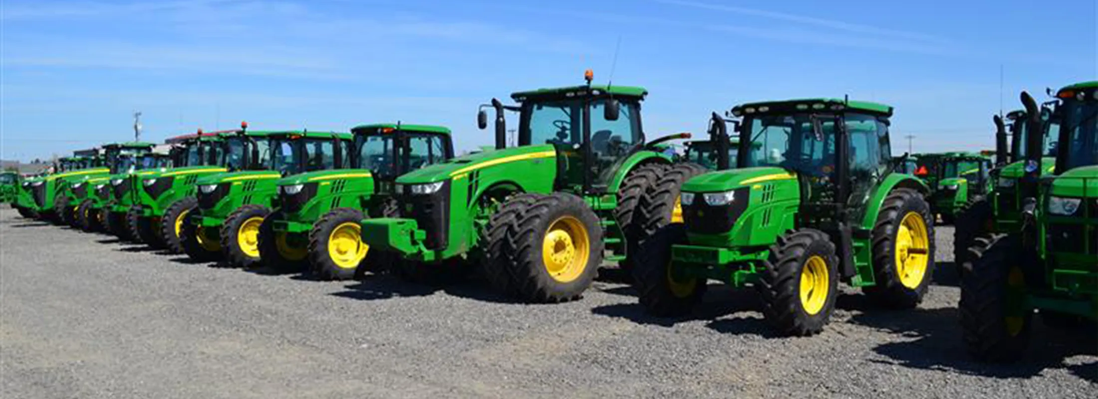 Row of farm equipment in dealer lot